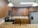 Well-equipped kitchen featuring granite countertops, stainless appliances, and ample cabinet space at 7679 Bent Bow Trl, Winter Park, FL 32792
