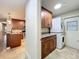 Laundry room with full-sized stacked washer dryer, wood cabinets and granite counters at 7679 Bent Bow Trl, Winter Park, FL 32792