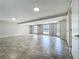 Bright living room featuring tile floors, recessed lighting, and multiple windows overlooking the landscaped backyard at 7679 Bent Bow Trl, Winter Park, FL 32792
