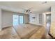 Spacious living room with carpet, tile floor, ceiling fan, and slider to backyard at 7679 Bent Bow Trl, Winter Park, FL 32792