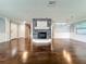 Stylish living room showcasing hardwood floors, a stone fireplace, and bright recessed lighting at 7679 Bent Bow Trl, Winter Park, FL 32792