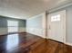 Elegant living room featuring hardwood floors, wainscoting detail, and a bright front door at 7679 Bent Bow Trl, Winter Park, FL 32792