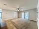 Open concept living room with tile floor, carpet, and sliding doors to backyard at 7679 Bent Bow Trl, Winter Park, FL 32792