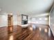 Expansive living room featuring hardwood floors and a stone fireplace at 7679 Bent Bow Trl, Winter Park, FL 32792