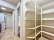 Walk-in pantry with multiple shelves and view into the kitchen and laundry room at 7679 Bent Bow Trl, Winter Park, FL 32792