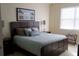Bedroom boasts a large window with blinds and a comfortable bed with decorative pillows at 7842 Holiday Isle Dr # 102, Belle Isle, FL 32812