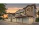 View of a multi-story home with an attached garage featuring a red tile roof and stucco walls at 7842 Holiday Isle Dr # 102, Belle Isle, FL 32812