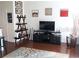 Well-lit living room with hardwood floors, contemporary decor, and a media center at 7842 Holiday Isle Dr # 102, Belle Isle, FL 32812