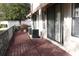 Outdoor patio features a wooden deck with tropical landscaping and a privacy fence at 7842 Holiday Isle Dr # 102, Belle Isle, FL 32812