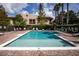 Community pool featuring lounge chairs and tropical landscaping at 7842 Holiday Isle Dr # 102, Belle Isle, FL 32812