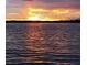 Scenic waterfront view featuring a sunset over the water, creating a peaceful and picturesque setting at 7842 Holiday Isle Dr # 102, Belle Isle, FL 32812