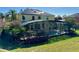 Back of the home featuring an enclosed pool and hot tub in a well-maintained yard at 8520 La Isla Dr, Kissimmee, FL 34747