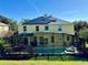 Back exterior view with a screened-in pool area and solar panels on the roof at 8520 La Isla Dr, Kissimmee, FL 34747