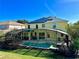 Beautiful backyard with a screened-in pool and solar panels on the roof at 8520 La Isla Dr, Kissimmee, FL 34747