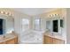 Bright bathroom features a corner soaking tub, double sink vanity, and neutral tile at 8520 La Isla Dr, Kissimmee, FL 34747