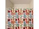 Colorful square patterned shower curtain covering the shower and bathtub at 8520 La Isla Dr, Kissimmee, FL 34747