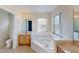 The spacious bathroom boasts a soaking tub, a window with natural light, and a separate toilet area at 8520 La Isla Dr, Kissimmee, FL 34747