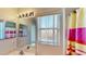 Bathroom featuring a vanity, large mirror with lights, and a window with a peek at a colorful shower curtain at 8520 La Isla Dr, Kissimmee, FL 34747