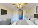 Serene bedroom with a ceiling fan, closet, and a view into an adjacent room with a shower at 8520 La Isla Dr, Kissimmee, FL 34747