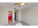 Bright bedroom with neutral carpet, a ceiling fan, and a glimpse of a shower with a colorful curtain at 8520 La Isla Dr, Kissimmee, FL 34747