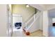 Inviting entryway with tile flooring, staircase, and a glimpse into the living area featuring a comfortable leather couch at 8520 La Isla Dr, Kissimmee, FL 34747