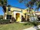 Beautiful two-story home with a well manicured front yard and palm trees at 8520 La Isla Dr, Kissimmee, FL 34747