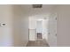 Hallway with stairs, white railing, and a thermostat at 8520 La Isla Dr, Kissimmee, FL 34747