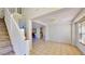 Open-concept living area with staircase, tile flooring, and views into the kitchen, creating a spacious atmosphere at 8520 La Isla Dr, Kissimmee, FL 34747