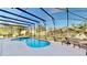 Sparkling pool with screened-in enclosure surrounded by concrete patio at 8520 La Isla Dr, Kissimmee, FL 34747