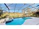 A screened in pool and hot tub featuring lush landscaping and neighborhood views at 8520 La Isla Dr, Kissimmee, FL 34747