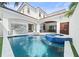 A luxurious pool and spa area with an outdoor kitchen, dining, and lounging spaces at 9743 Covent Garden Dr, Orlando, FL 32827