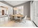 Elegant dining room featuring modern chandelier, neutral tones, and views to the exterior at 9743 Covent Garden Dr, Orlando, FL 32827