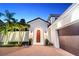 Inviting arched entryway with a wooden door, lanterns, and decorative potted plants at 9743 Covent Garden Dr, Orlando, FL 32827