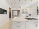 Bright, modern kitchen features a marble countertop island and gold pendant lighting at 9743 Covent Garden Dr, Orlando, FL 32827
