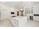 Bright, modern kitchen features a marble countertop island with built-in gas range at 9743 Covent Garden Dr, Orlando, FL 32827