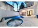 A serene swimming pool and hot tub area with an outdoor kitchen and lounge chairs at 9743 Covent Garden Dr, Orlando, FL 32827