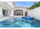 An inviting backyard swimming pool and spa with outdoor seating and dining spaces at 9743 Covent Garden Dr, Orlando, FL 32827