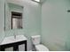 Comfortable bathroom featuring a toilet, simple sink, and neutral green paint at 102 Ichabod Trl, Longwood, FL 32750