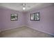 Simple bedroom featuring two windows, neutral carpet, light pink walls, and ceiling fan at 102 Ichabod Trl, Longwood, FL 32750