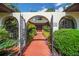 A walkway leads to the home through wrought iron gates and lush landscaping at 102 Ichabod Trl, Longwood, FL 32750