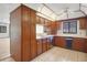 Traditional kitchen featuring wood cabinets, tile flooring and bright lighting at 102 Ichabod Trl, Longwood, FL 32750