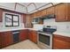 Well-lit kitchen with wood cabinets, stainless steel appliances, and white countertops at 102 Ichabod Trl, Longwood, FL 32750