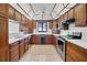 Well-lit kitchen featuring stainless appliances, tile floors, and ample cabinet space at 102 Ichabod Trl, Longwood, FL 32750