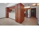 Kitchen with wood cabinets, stainless steel appliances, and view into carpeted bonus room at 102 Ichabod Trl, Longwood, FL 32750