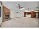 Large living room with a brick fireplace, ceiling fans, and an adjoining kitchen at 102 Ichabod Trl, Longwood, FL 32750