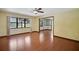 Open living room with hardwood floors and abundant natural light from large windows at 102 Ichabod Trl, Longwood, FL 32750