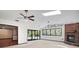 Spacious living room with brick fireplace, ceiling fans, and sliding door access to the pool at 102 Ichabod Trl, Longwood, FL 32750