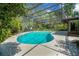 Enjoy the privacy and fun in this screened pool with a slide, surrounded by lush greenery at 102 Ichabod Trl, Longwood, FL 32750