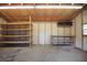 Inside of a backyard shed featuring exposed wood beams, shelving and a concrete floor at 102 Ichabod Trl, Longwood, FL 32750
