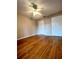 Spacious bedroom featuring wood-look flooring, a lighted ceiling fan, and multiple closets for ample storage space at 1057 S Hiawassee Rd # 1913, Orlando, FL 32835